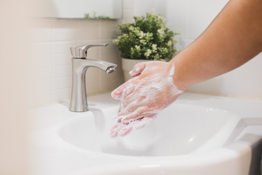 Closeup of a person washing their hands for 20 seconds to reduce the spread of COVID-19 in Littleton, CO