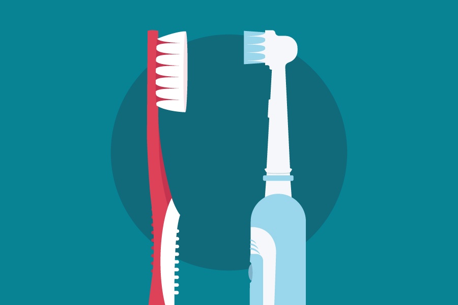 A red manual toothbrush faces a blue and white electric toothbrush on a teal background